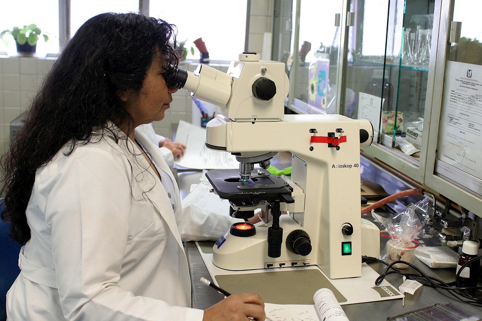 A close-up of swollen legs and cross over toe being examined by a medical professional.